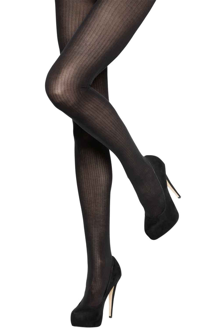 Black rib tights worn with black high heels on a white background