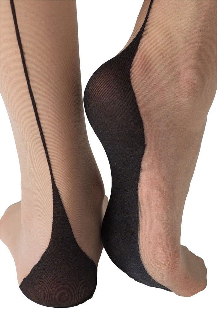 Natural coloured seamed tights worn by a model on a white background