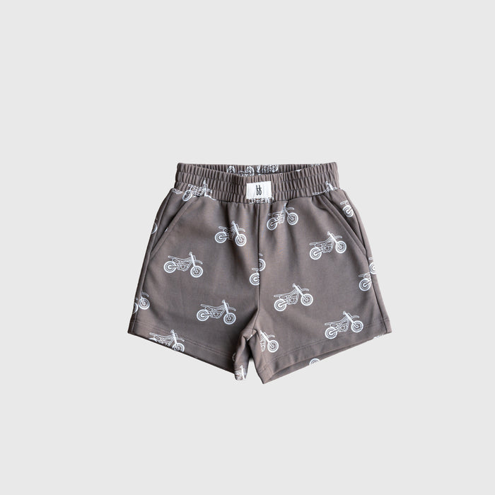 The forever french baby French Terry Short Set | Dirt Bike features gray children's shorts with an elastic waistband, side pockets, and a white motorcycle print—great to pair as a cool kids matching set. Displayed on a plain light gray background.