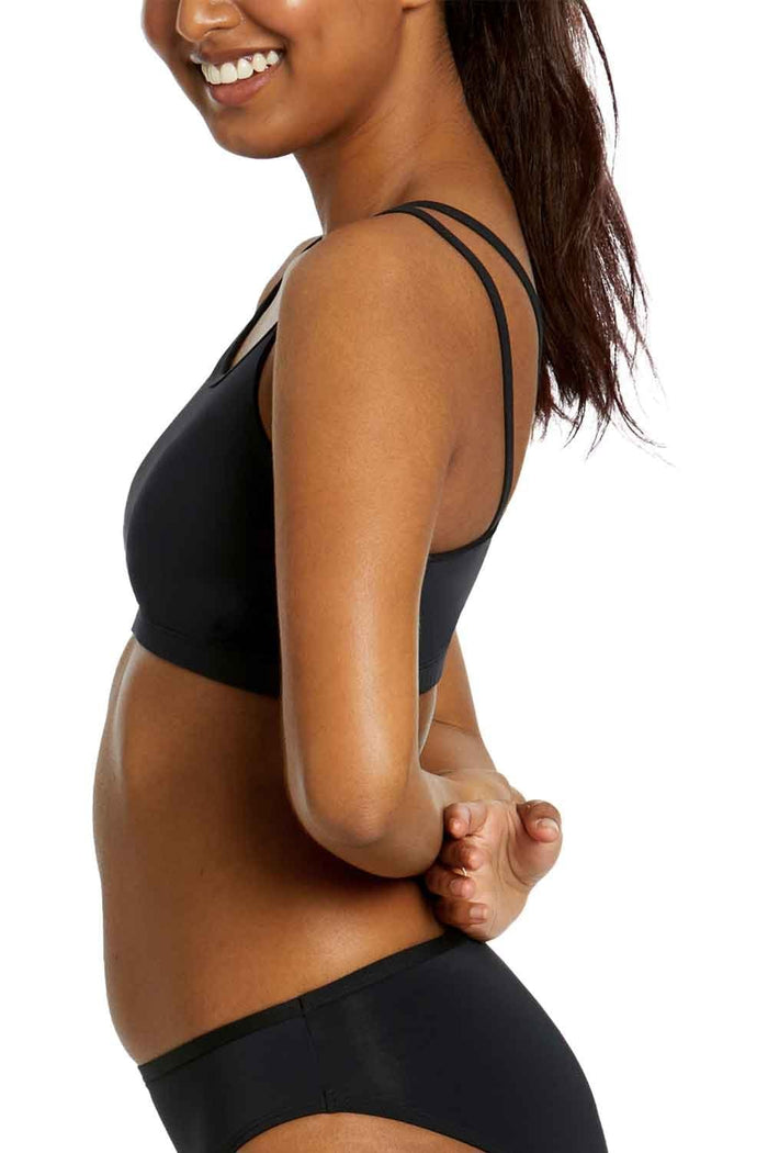 Person wearing a girls period swim bikini top on a white background