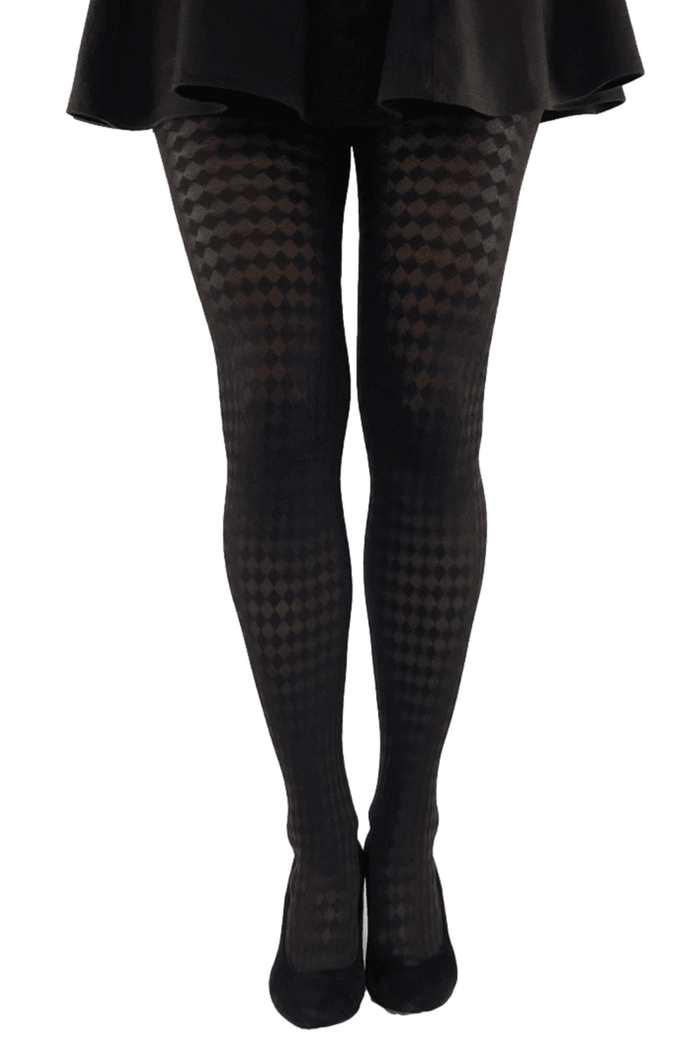 Black jester checkered tights worn with a black skirt on a white background