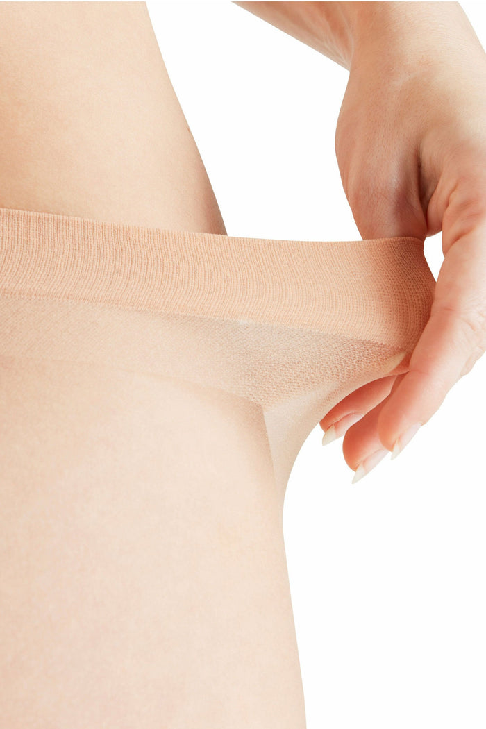 Close-up of a person wearing natural tights with a white background