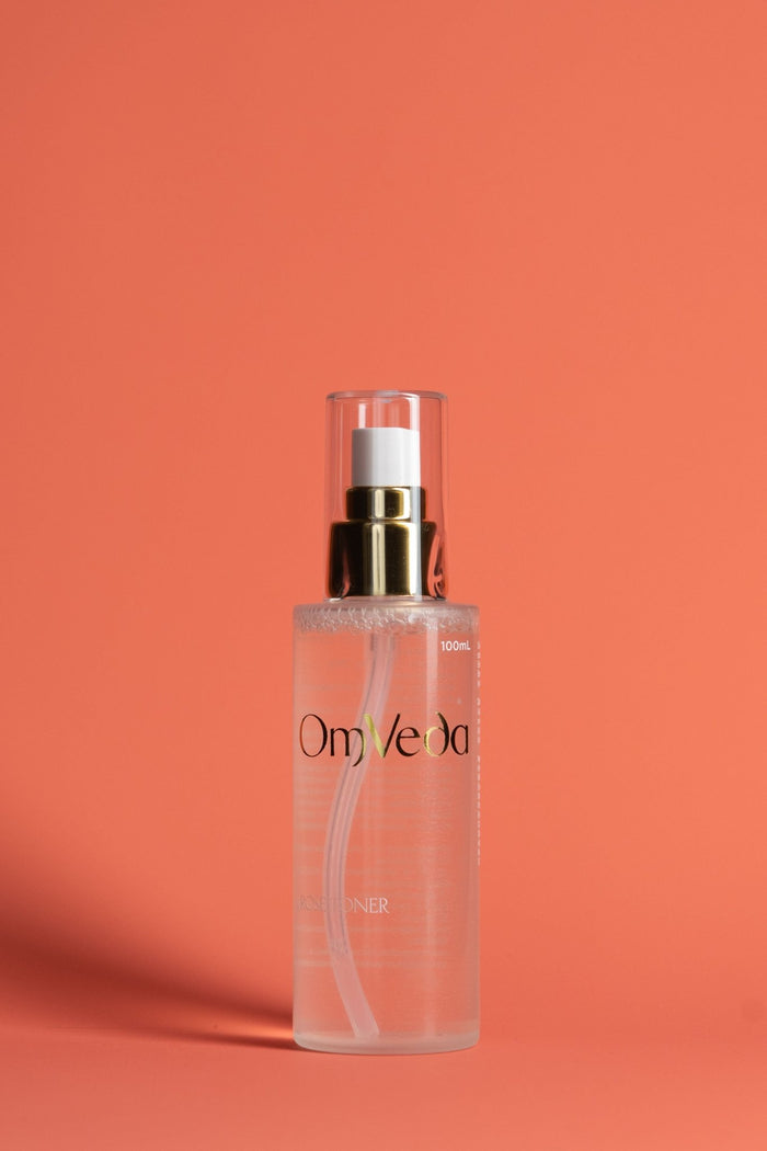 OmVeda rose toner 100 ml clear pump bottle with rose-tinted liquid