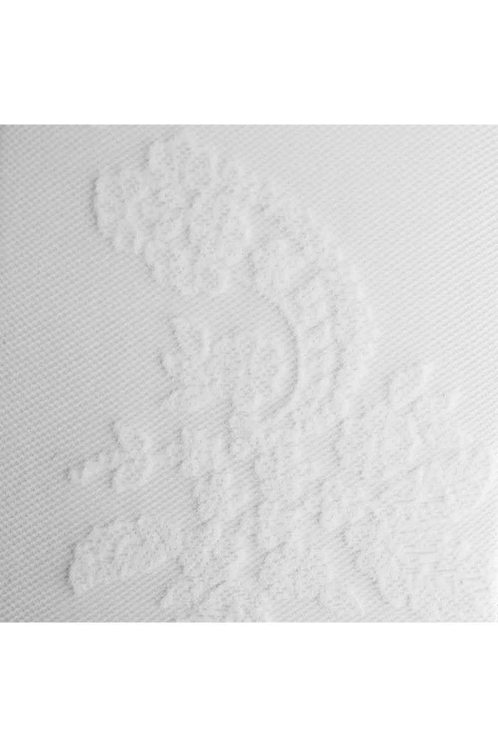 Close-up of textured white fabric with a paisley pattern