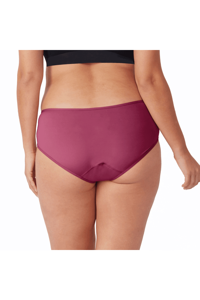 Person wearing a plum coloured period midi brief on a white background