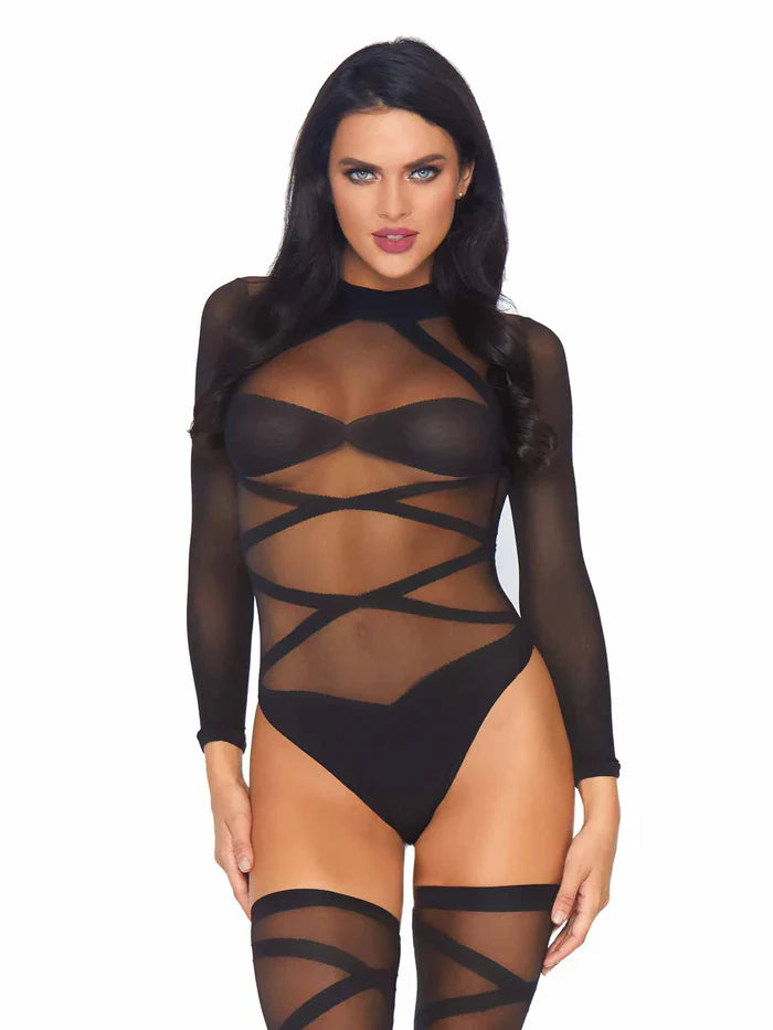 Model wearing a black strappy bodysuit and hold ups on a white background