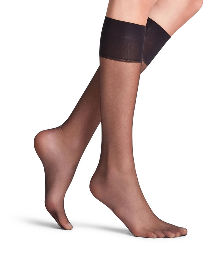 Falke knee highs worn by a person on a white background