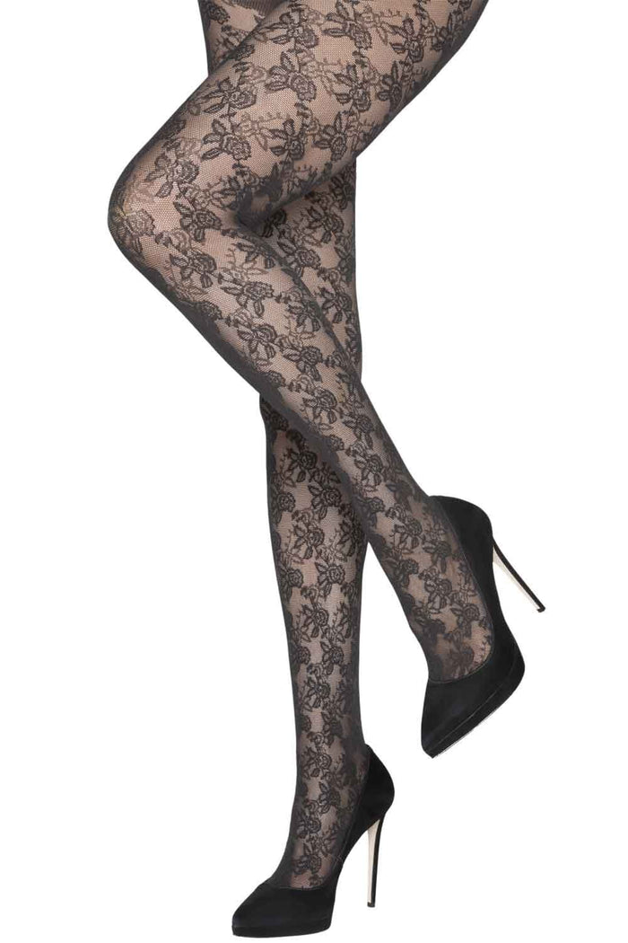 Black lace floral tights worn with black high heels on a white background