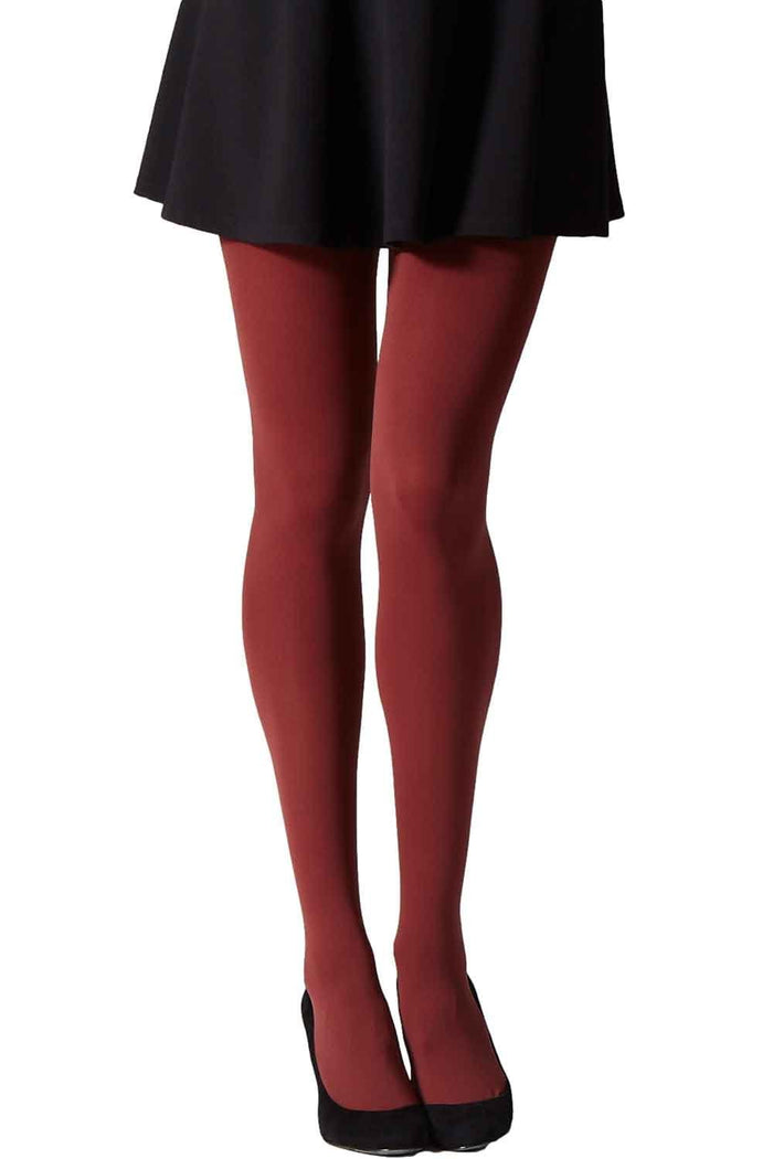 Red tights worn with a black skirt and shoes on a white background