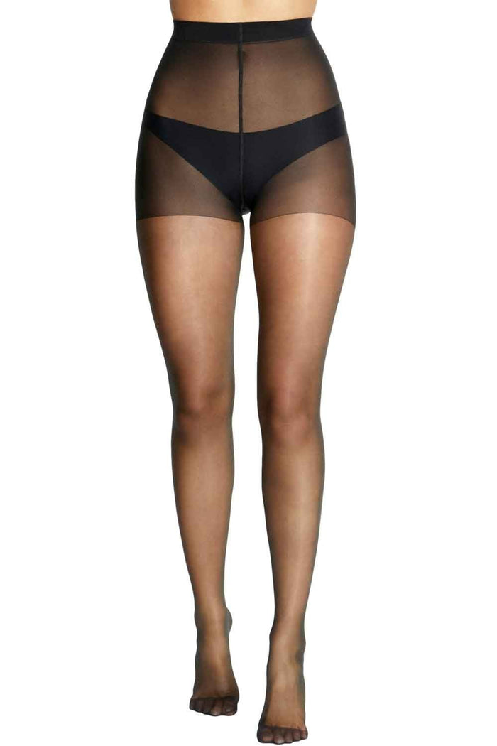 Barely black tights worn by a model on a white background