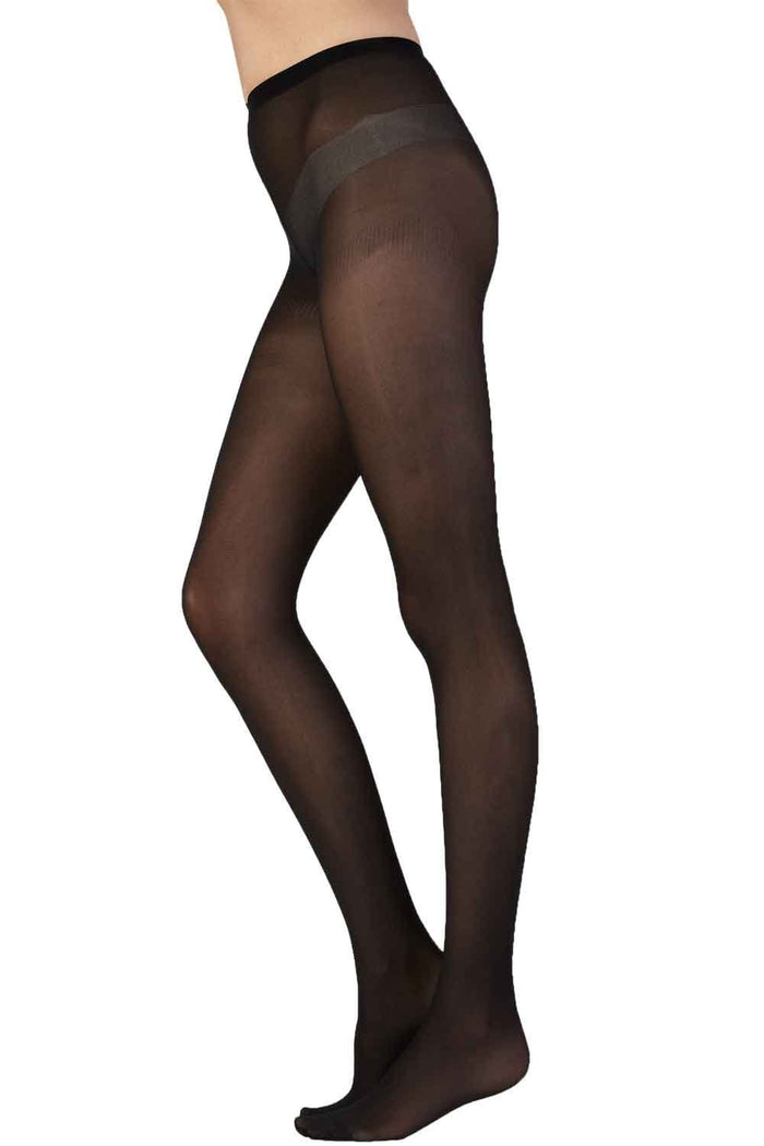 Black tights worn by a person on a white background