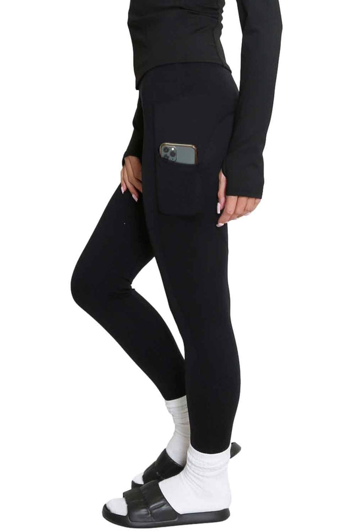 Model  wearing Allana black leggings with a pocket on a white background