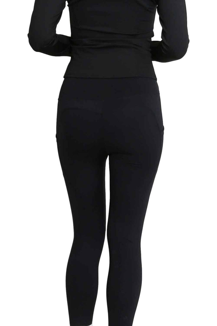 Model  wearing black leggings on a white background