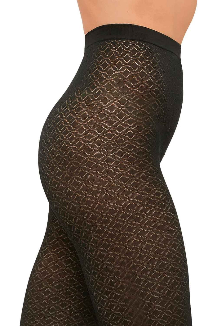 Black jacquard  patterned tights worn by a model on a white background