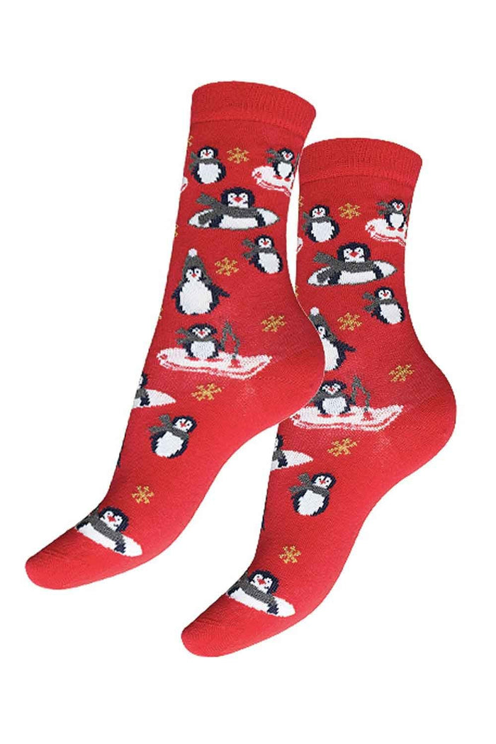 Red socks with penguin pattern on a white background