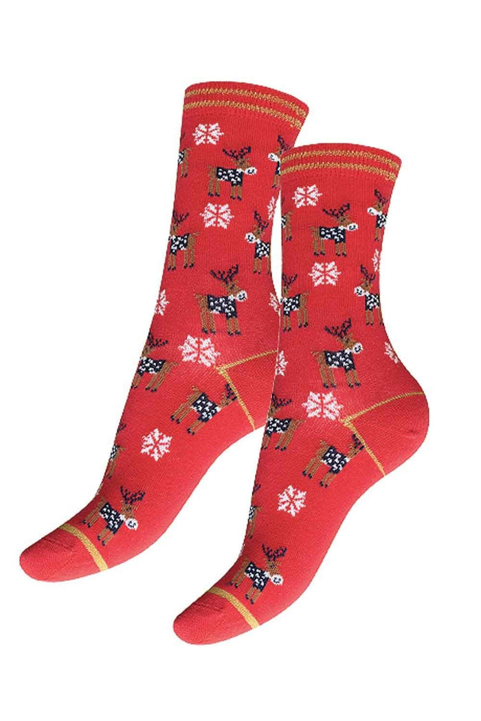 Red socks with reindeer and snowflake pattern on a white background