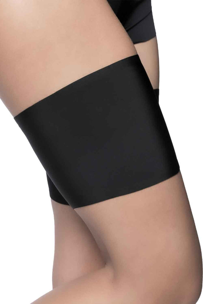 Black ant-chafing band being worn on a leg against a white background