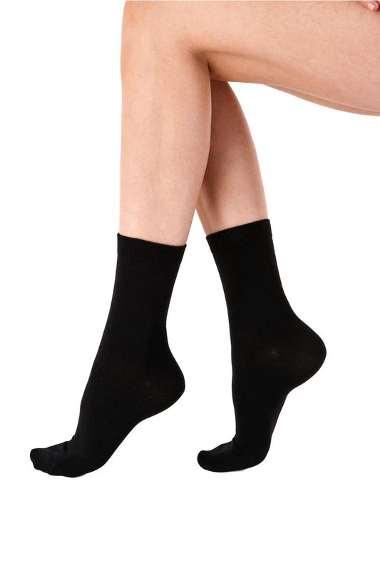 Black socks worn by a person on a white background