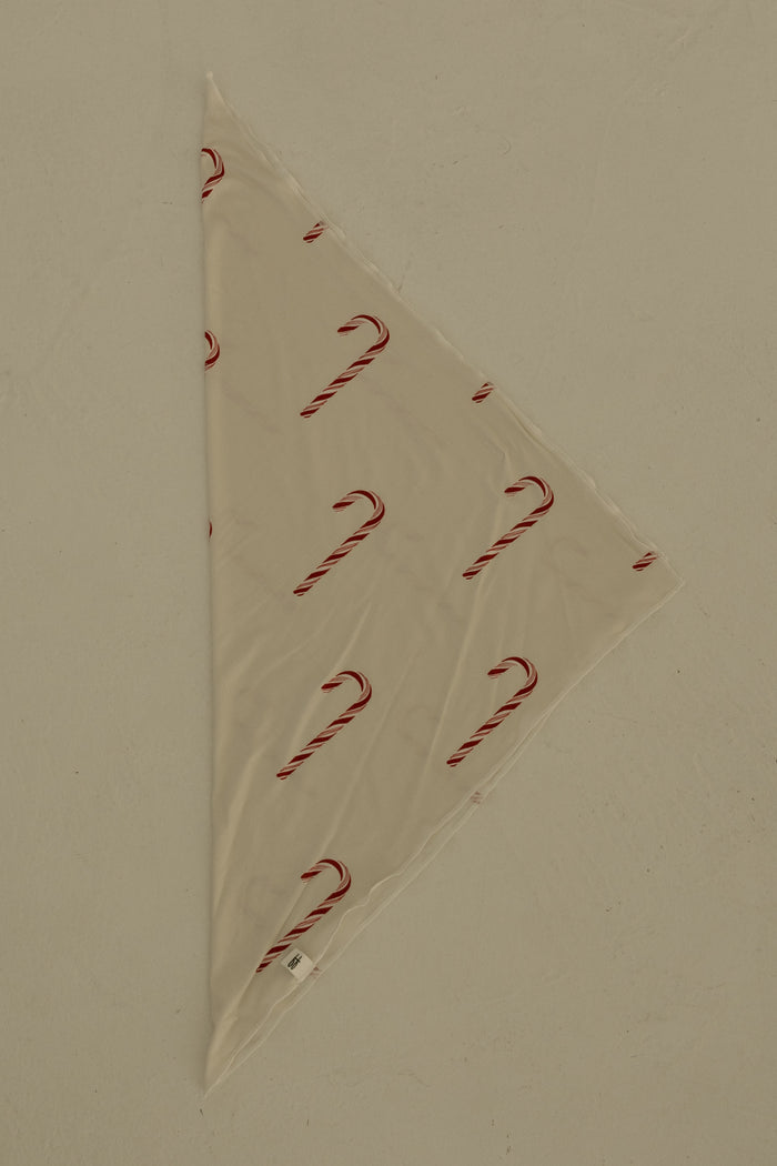 The Bamboo Bandana | Candy Cane by forever french baby is a cream-colored, triangular pet bandana with a festive candy cane print, shown flat on a light surface.