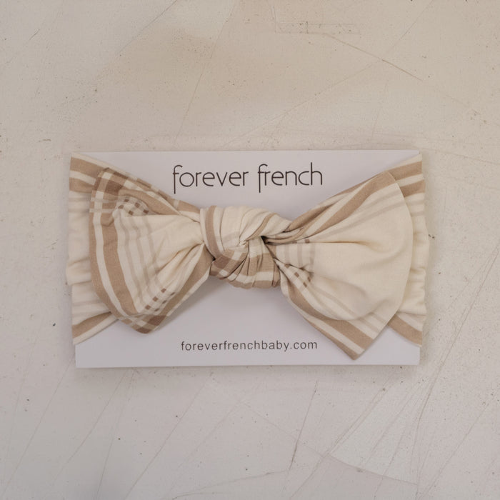 The Bamboo Head Wrap | Ellis Plaid by forever french baby is tied in a bow and displayed on a branded card with "foreverfrenchbaby.com," set on a light textured background.