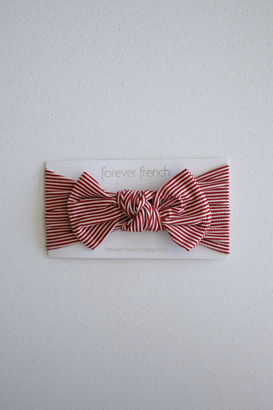 A Bamboo Head Wrap in Peppermint Stripe Ribbed from forever french baby is displayed on a white card labeled "forever french" against a light textured background.