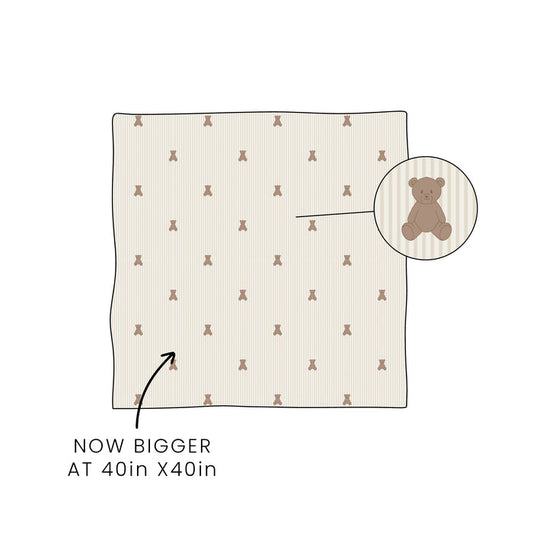 The forever french baby Bamboo Swaddle | Teddy now comes in a larger 40in x 40in size. An inset circle spotlights the teddy bear pattern, with an arrow pointing to the swaddle and text reading "NOW BIGGER AT 40in X 40in.