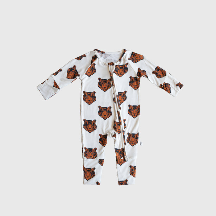 The Bamboo Zip Pajamas | Tigers by forever french baby features a white base with orange tiger faces, crafted from hypo-allergenic material for gentle comfort.