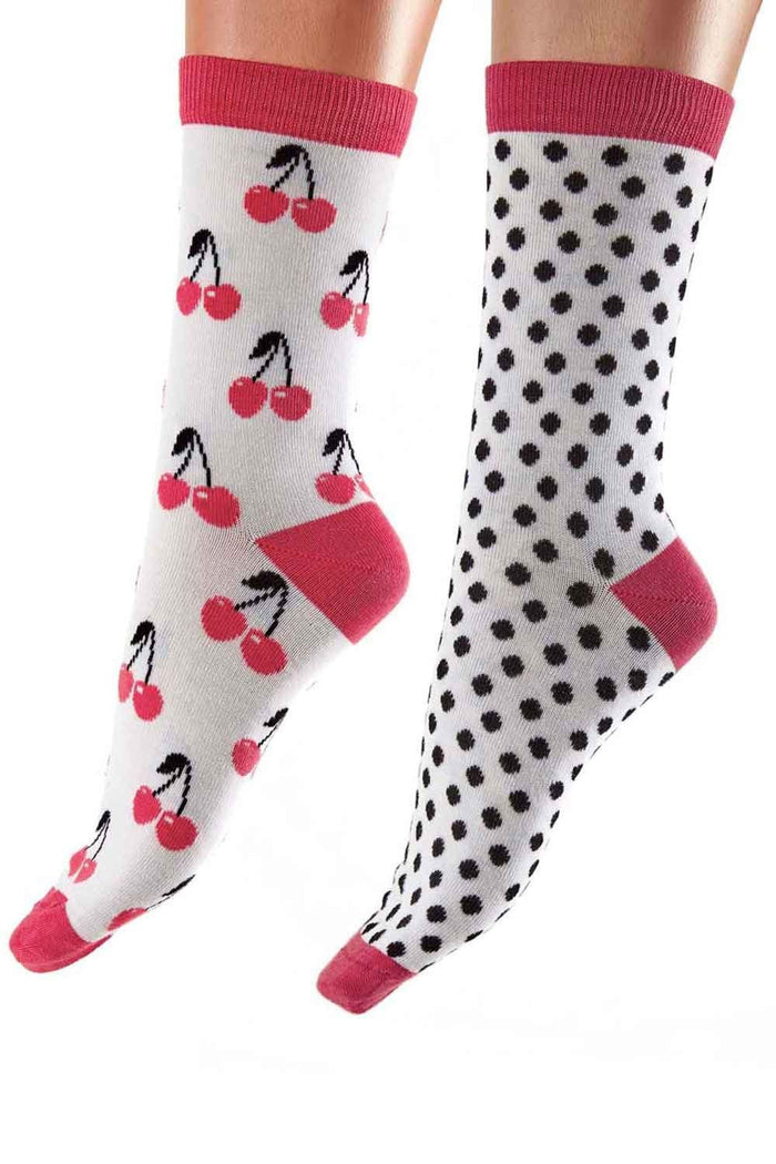 Two pairs of socks with cherry pattern and polka dot pattern on a white background