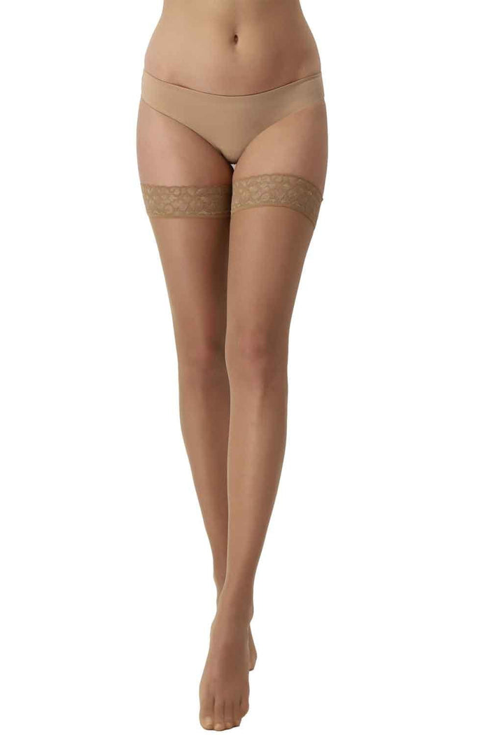 Beige shold ups  with lace top on a white background