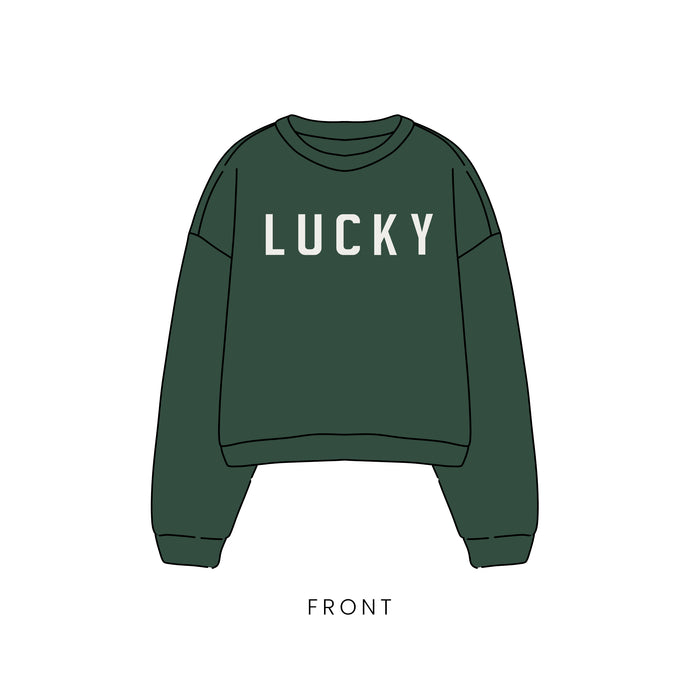 Front view of the forever french baby Child Sweatshirt | Lucky—a dark green St. Patrick’s Day kids sweatshirt with bold white "LUCKY" lettering, perfect for family matching outfits.
