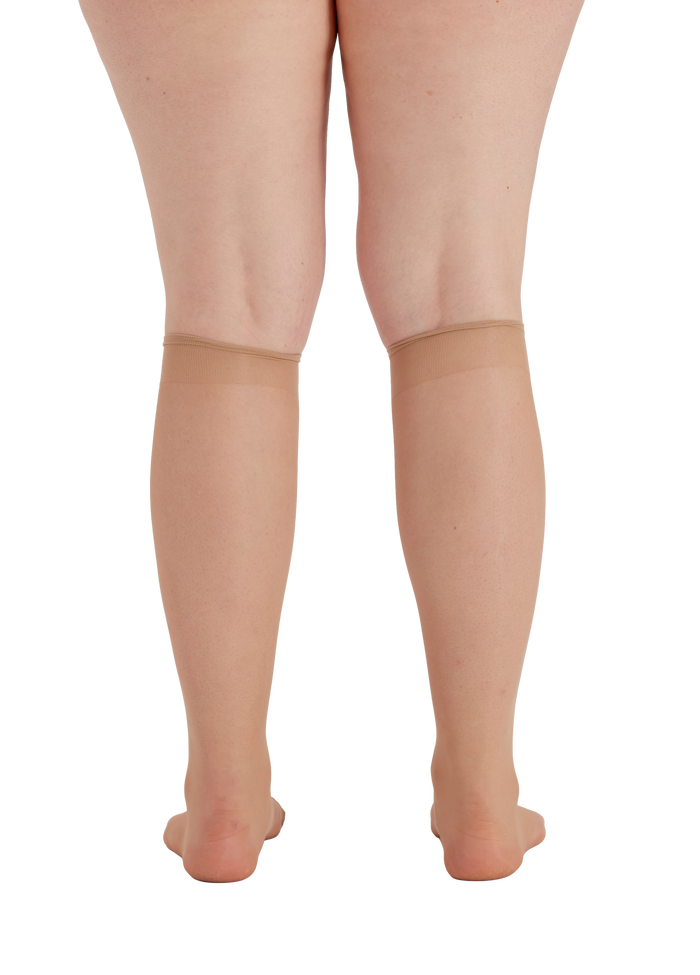 Nude knee highs worn by a person on a square patterned  background