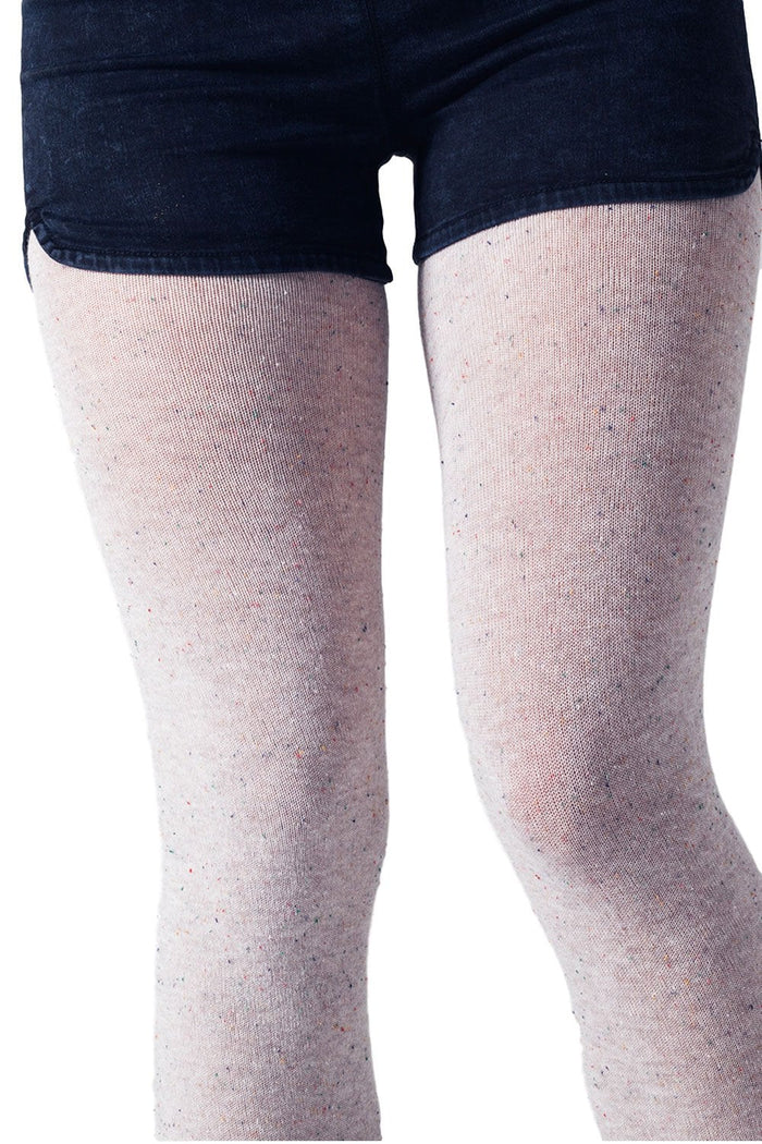 Legs wearing ceam speckled patterned  tights with a white background