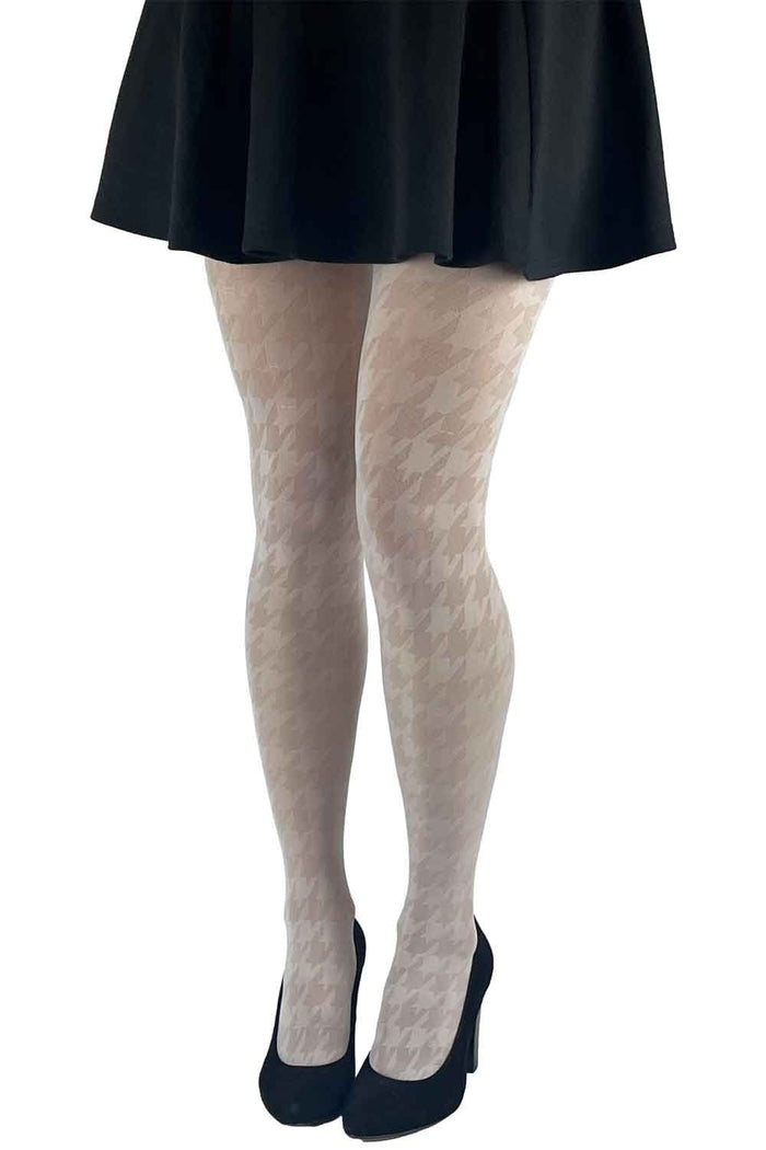 Cream tights worn with a black skirt and shoes on a white background