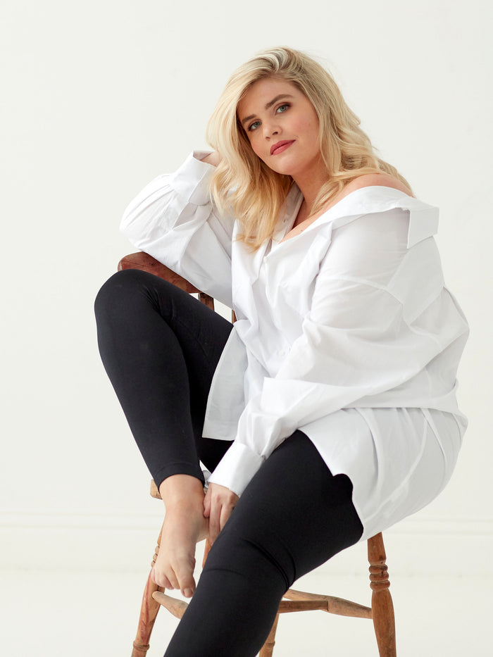 Model wearing black leggings on a white background