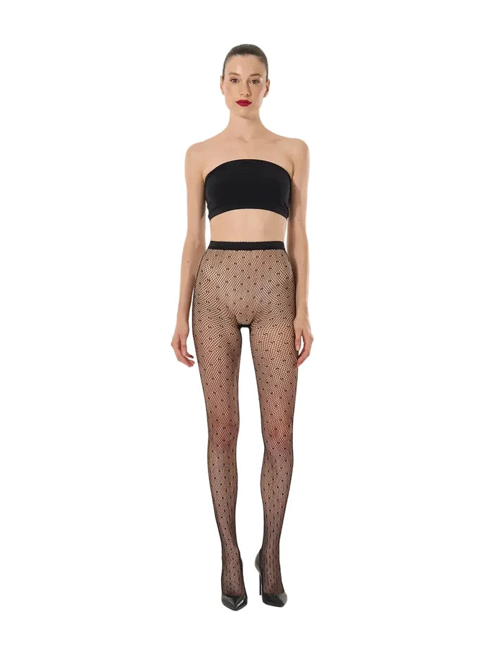 Black polka dot knitted tights worn on model on a white background