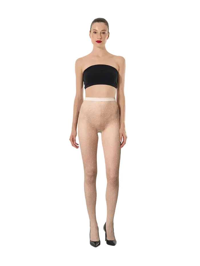 Model wearing polka dot beige knitted tights and black cropped top on a white background