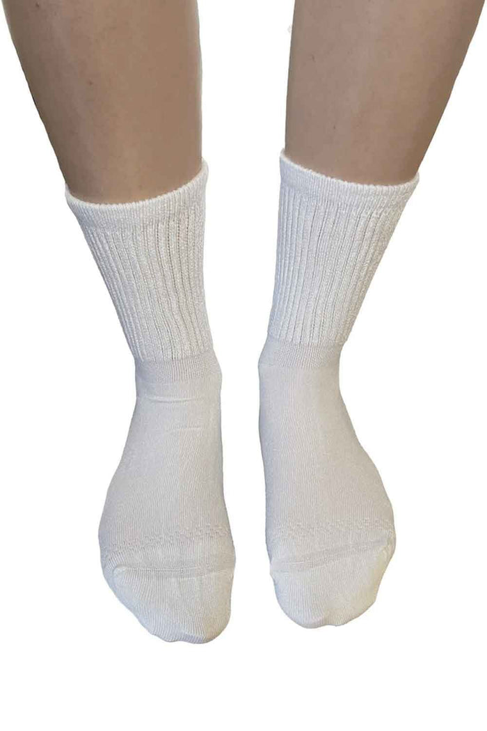 White extra wide bamboo super soft socks worn on a white background