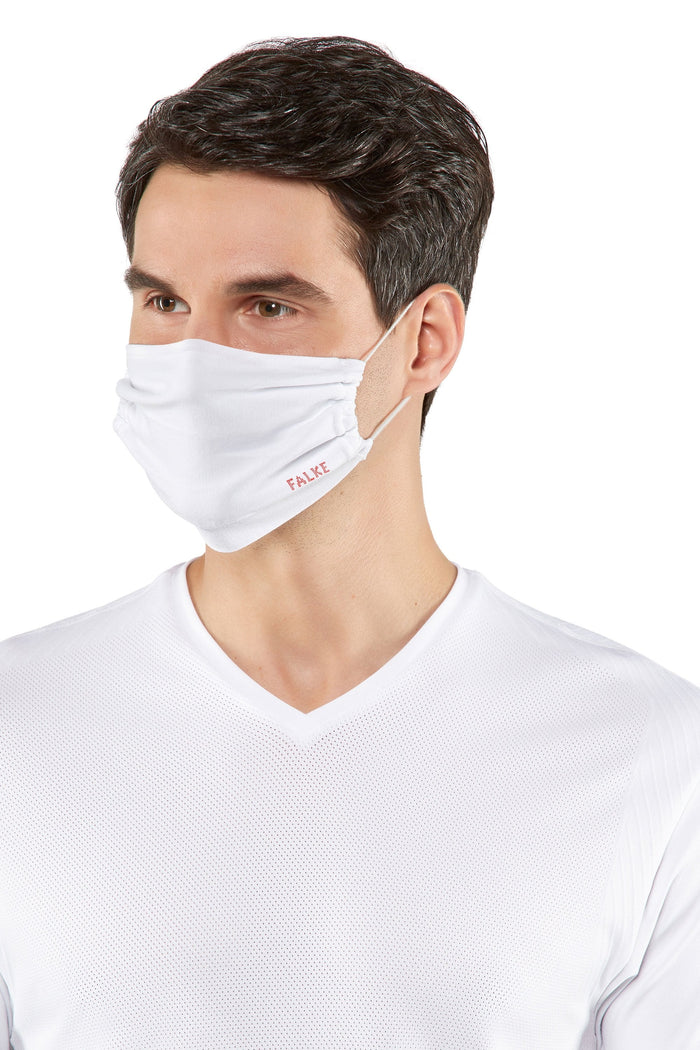 Man wearing a white face mask with a brand logo on a white background