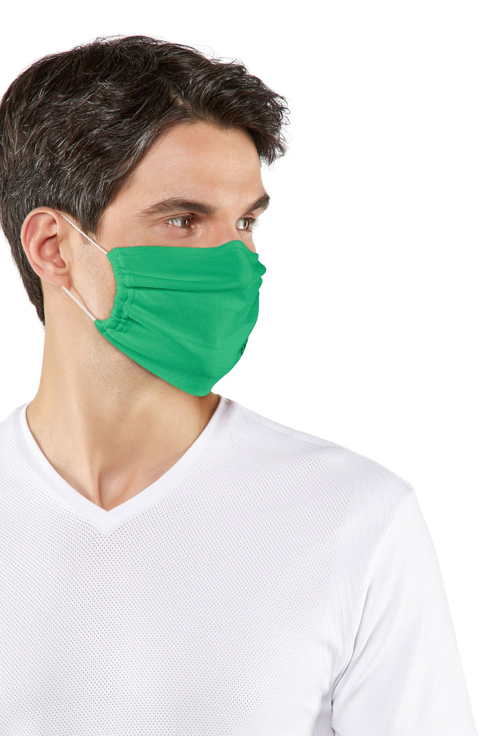 Man wearing a green falke  face mask against a white background