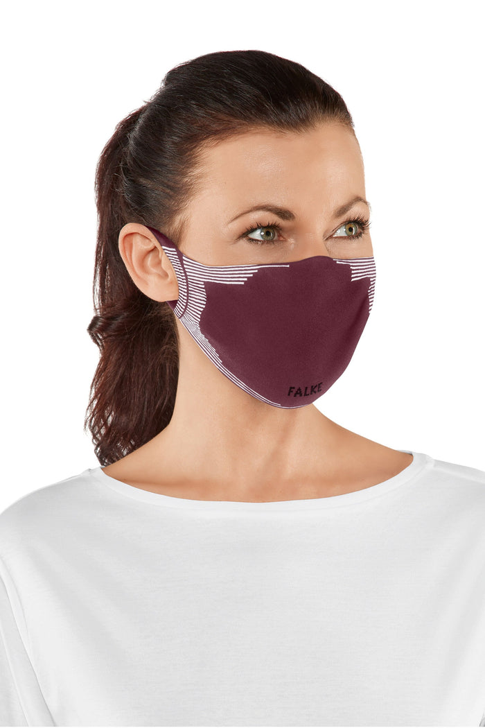 Woman wearing a bordeaux face mask with a white background