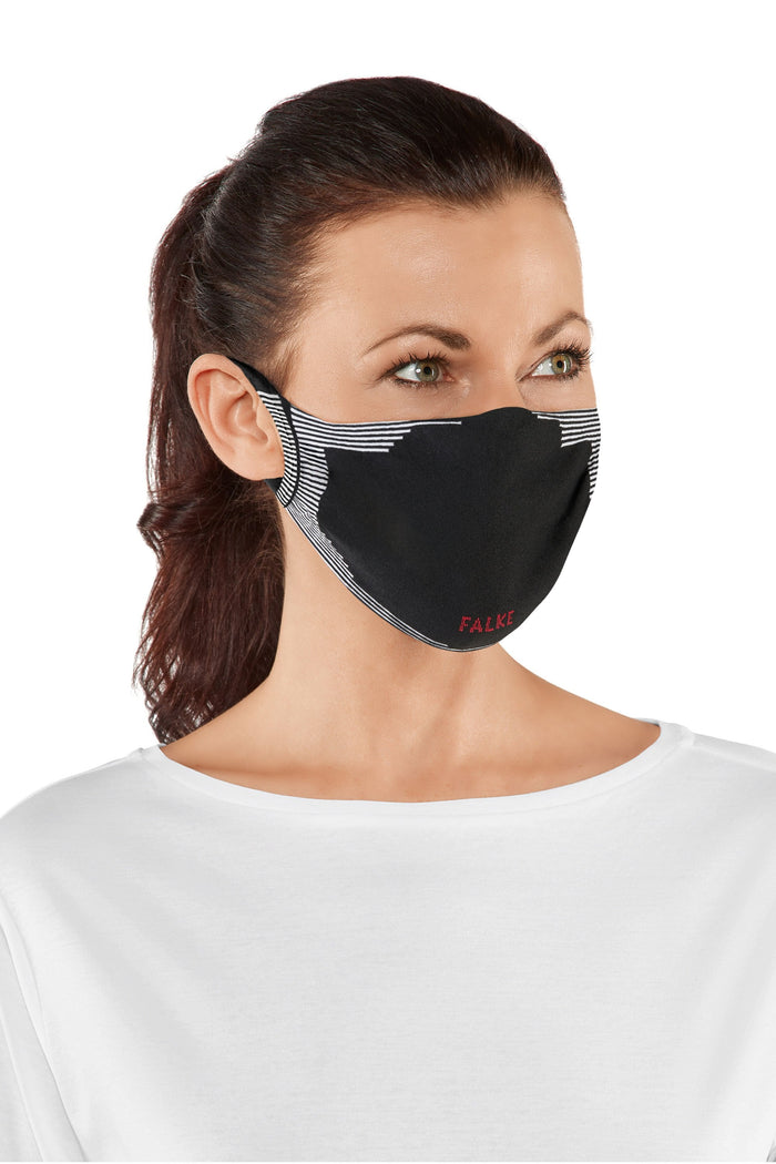 Woman wearing a black face mask with a patterned strap on a white background