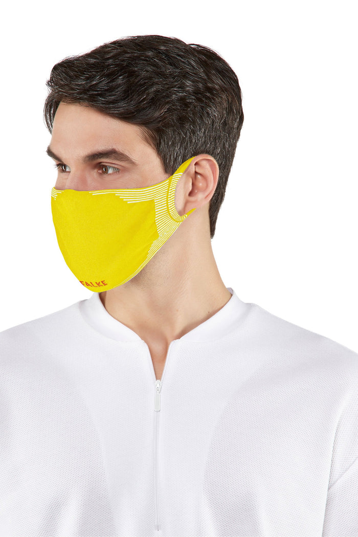 Man wearing a yellow face mask against a white background