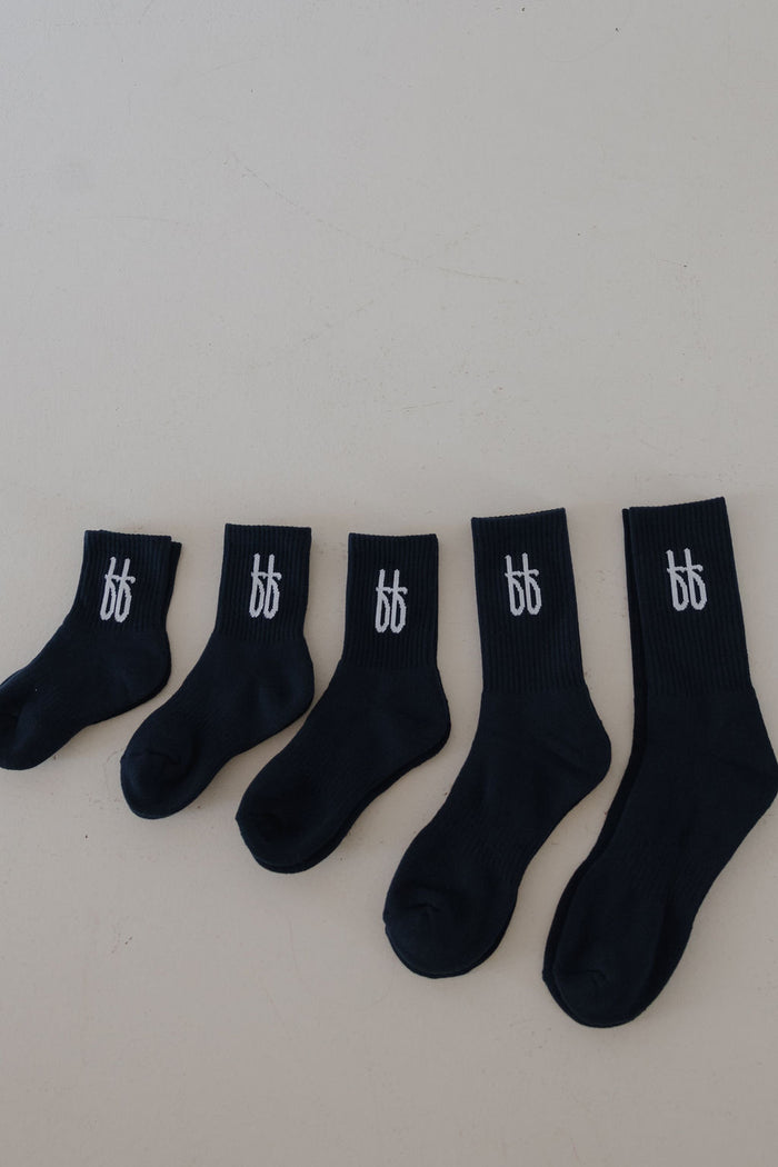 Five pairs of navy ff Crew Socks by forever french baby, in various sizes, are lined up from smallest to largest. Each features a white "bb" logo near the cuff. Perfect kids socks with a classic style, set on a plain light background.