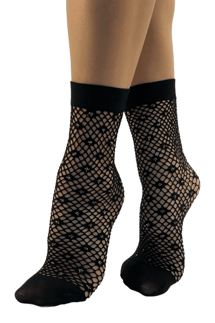 Black fishnet socks with a pattern worn by a model on a white background