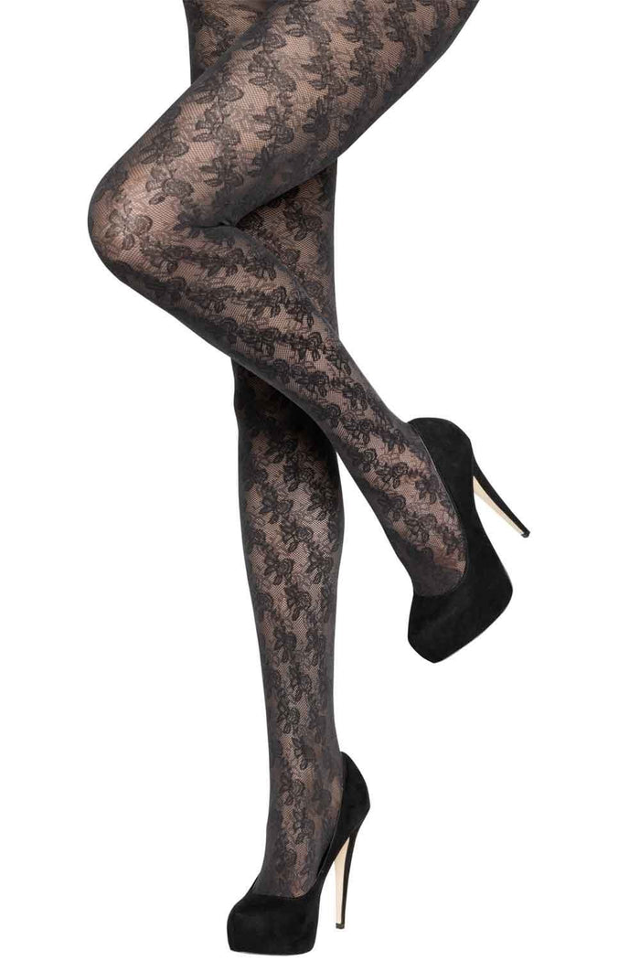 Black floral  tights worn with black high-heeled shoes on a white background