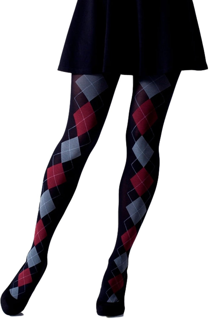 Black argyle patterned tights worn with a black skirt on a white background