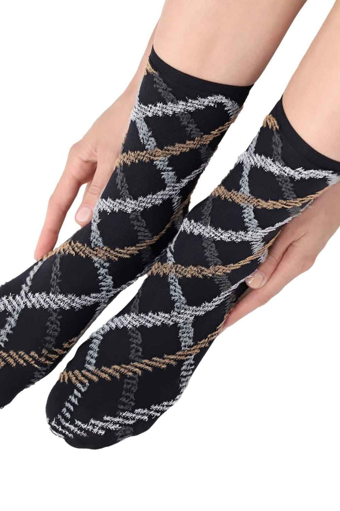 Black and grey tartan  socks with geometric pattern held by a person on a white background