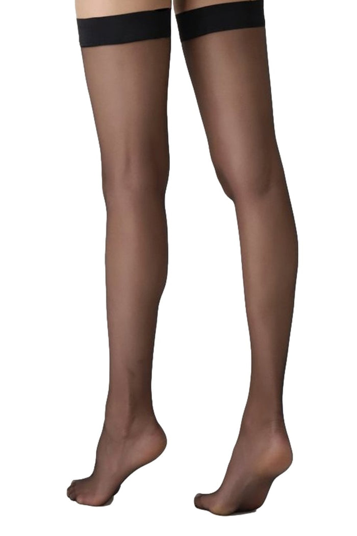 Black sheer hold ups worn by a person on a white background
