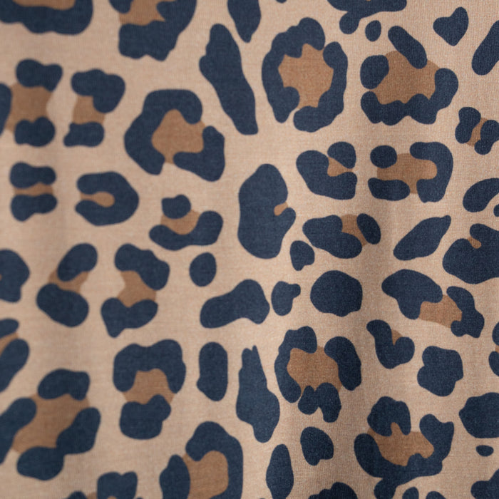 Close-up of forever french baby's Women's Bamboo Short Set | Leopard, crafted from hypoallergenic bamboo with brown and black leopard spots on a light tan background. The print features irregular, organic-shaped patterns across the fabric.