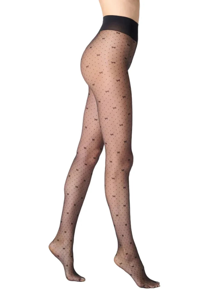 Black patterned tights worn by a person on a white background